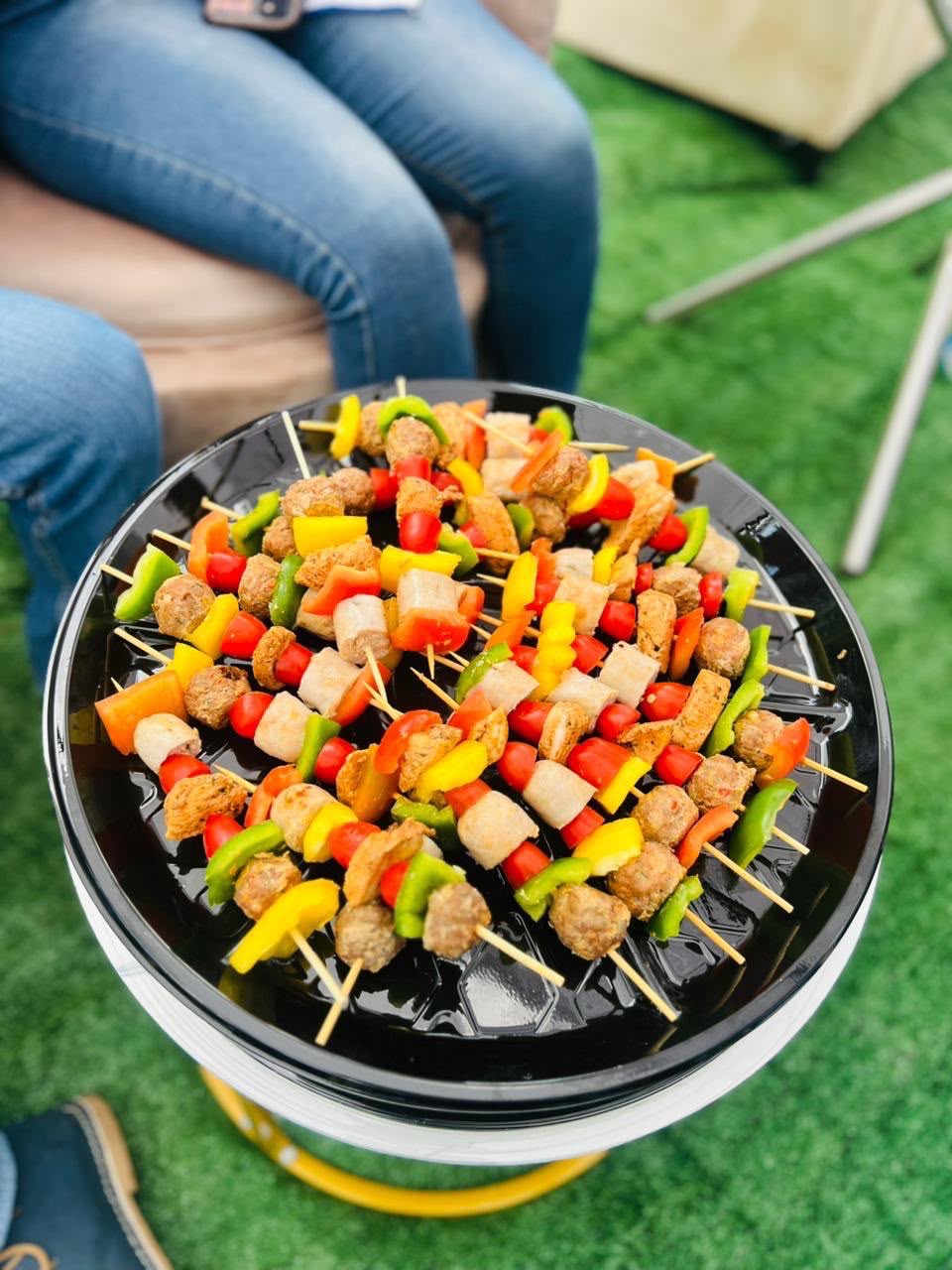 Skewers of grilled meat and colourful peppers prepared for a spit braai feast